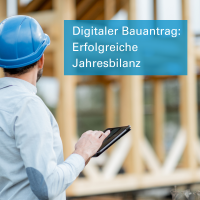 Ein Architekt schaut auf einer Baustelle etwas in einem Tablet-PC nach. Text: Digitaler Bauantrag: Erfolgreiche Jahresbilanz